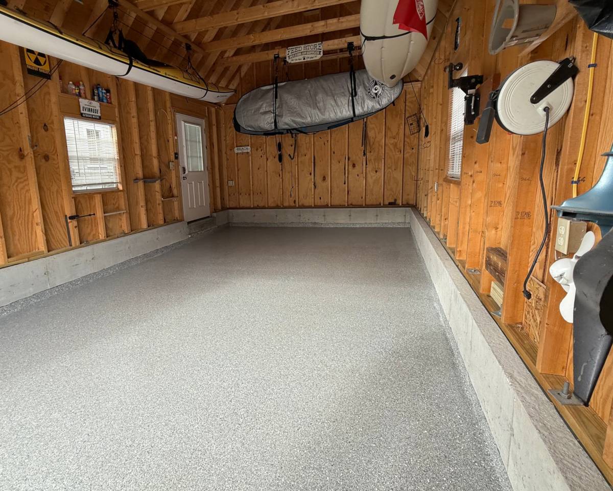 an epoxy floor in a residential garage with gray and white flake color